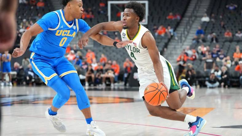 Nov 20, 2022; Las Vegas, Nevada, USA; Baylor Bears guard LJ Cryer (4) dribbles against UCLA Bruins guard Jaylen Clark (0) during the second half at T-Mobile Arena. Mandatory Credit: Stephen R. Sylvanie-USA TODAY Sports