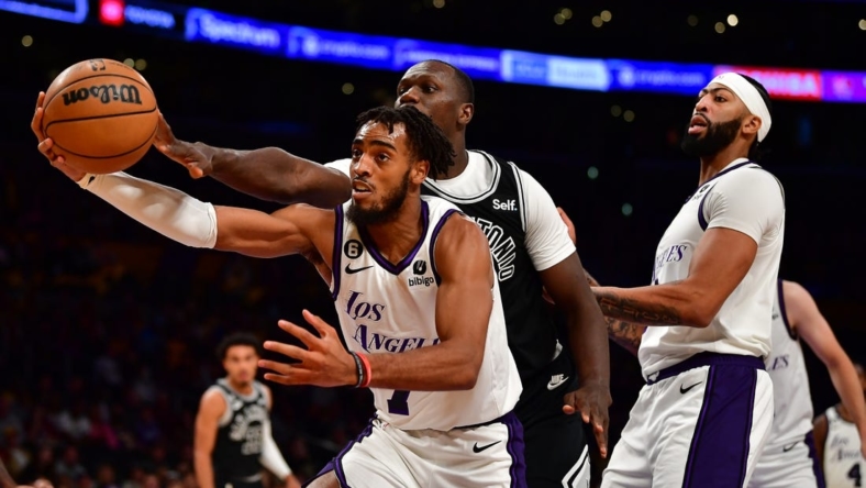 Nov 20, 2022; Los Angeles, California, USA; Los Angeles Lakers forward Troy Brown Jr. (7) plays for the rebound againt San Antonio Spurs center Gorgui Dieng (41) during the first half at Crypto.com Arena. Mandatory Credit: Gary A. Vasquez-USA TODAY Sports