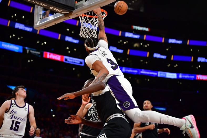 Nov 20, 2022; Los Angeles, California, USA; Los Angeles Lakers forward Anthony Davis (3) is fouled by San Antonio Spurs center Gorgui Dieng (41) during the second half at Crypto.com Arena. Mandatory Credit: Gary A. Vasquez-USA TODAY Sports