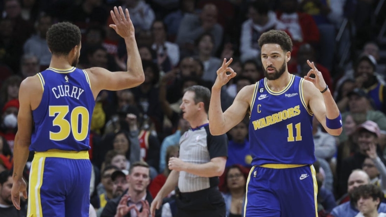 Nov 20, 2022; Houston, Texas, USA; Golden State Warriors guard Klay Thompson (11) and guard Stephen Curry (30) celebrate after a play during the first quarter against the Houston Rockets at Toyota Center. Mandatory Credit: Troy Taormina-USA TODAY Sports