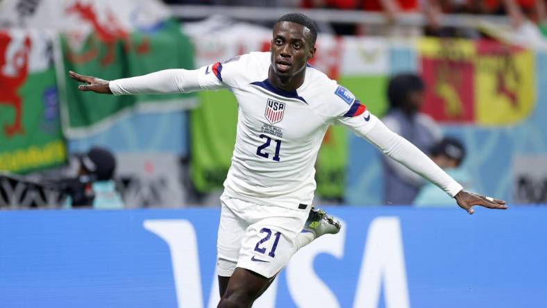 Nov 21, 2022; Al Rayyan, Qatar; United States of America forward Timothy Weah (21) reacts after scoring a goal against Wales during the first half during a group stage match during the 2022 FIFA World Cup at Ahmed Bin Ali Stadium. Mandatory Credit: Yukihito Taguchi-USA TODAY Sports