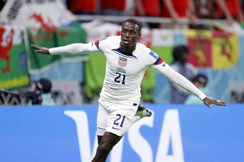 Nov 21, 2022; Al Rayyan, Qatar; United States of America forward Timothy Weah (21) reacts after scoring a goal against Wales during the first half during a group stage match during the 2022 FIFA World Cup at Ahmed Bin Ali Stadium. Mandatory Credit: Yukihito Taguchi-USA TODAY Sports