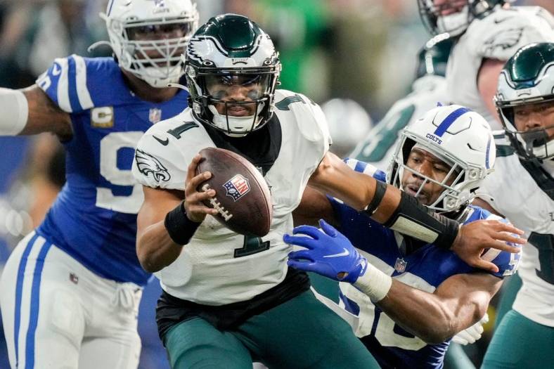 Philadelphia Eagles quarterback Jalen Hurts (1) evades Indianapolis Colts defenders on a fourth down play Sunday, Nov. 20, 2022, during a game against the Philadelphia Eagles at Lucas Oil Stadium in Indianapolis.