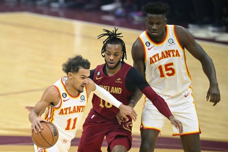 Nov 21, 2022; Cleveland, Ohio, USA; Cleveland Cavaliers guard Darius Garland (10) tries to get between Atlanta Hawks guard Trae Young (11) and center Clint Capela (15) in the first quarter at Rocket Mortgage FieldHouse. Mandatory Credit: David Richard-USA TODAY Sports