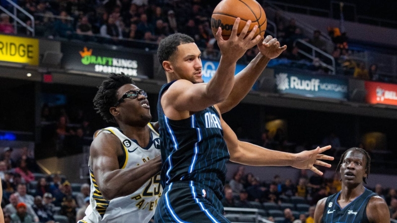 Nov 21, 2022; Indianapolis, Indiana, USA; Orlando Magic guard Jalen Suggs (4) rebounds the ball while Indiana Pacers forward Jalen Smith (25) defends in the first quarter at Gainbridge Fieldhouse. Mandatory Credit: Trevor Ruszkowski-USA TODAY Sports