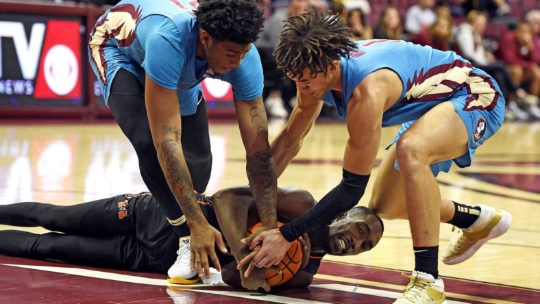 Nov 21, 2022; Tallahassee, Florida, USA; Mercer Bears guard Shawn Walker (25) fights for a loose ball with Florida State Seminoles guard Cam'Ron Fletcher (21) and guard Jalen Warley (1) during the first half at Donald L. Tucker Center. Mandatory Credit: Melina Myers-USA TODAY Sports