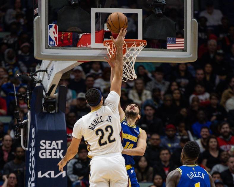 Nov 21, 2022; New Orleans, Louisiana, USA;  New Orleans Pelicans forward Larry Nance Jr. (22) dunks the ball against Golden State Warriors guard Ty Jerome (10) during the first half at Smoothie King Center. Mandatory Credit: Stephen Lew-USA TODAY Sports