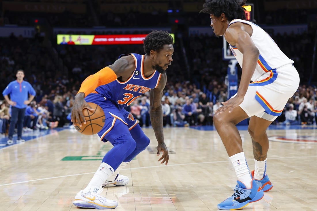 Nov 21, 2022; Oklahoma City, Oklahoma, USA; New York Knicks forward Julius Randle (30) drives against Oklahoma City Thunder forward Jalen Williams (8) during the second quarter at Paycom Center. Mandatory Credit: Alonzo Adams-USA TODAY Sports