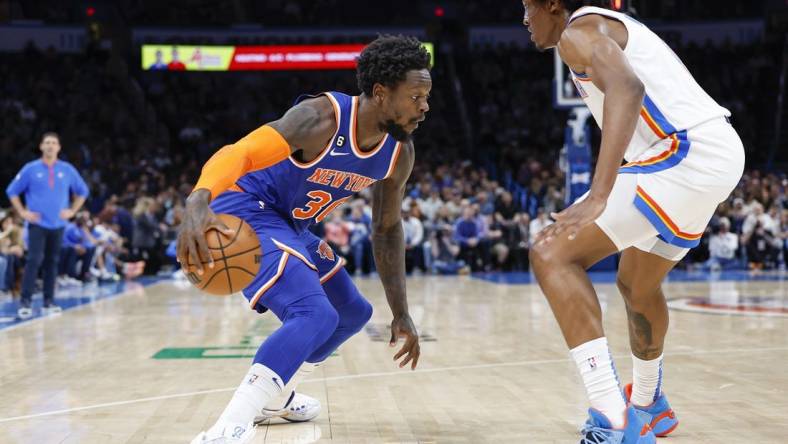 Nov 21, 2022; Oklahoma City, Oklahoma, USA; New York Knicks forward Julius Randle (30) drives against Oklahoma City Thunder forward Jalen Williams (8) during the second quarter at Paycom Center. Mandatory Credit: Alonzo Adams-USA TODAY Sports