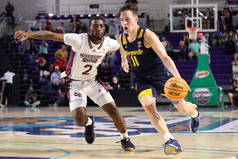 Nov 21, 2022; Fort Myers, Florida, USA;  Marquette Golden Eagles guard Tyler Kolek (11) drives to the basket past Mississippi State Bulldogs guard Jamel Horton Jr. (2) in the first half during the Fort Myers Tip-off at Suncoast Credit Union Arena. Mandatory Credit: Nathan Ray Seebeck-USA TODAY Sports