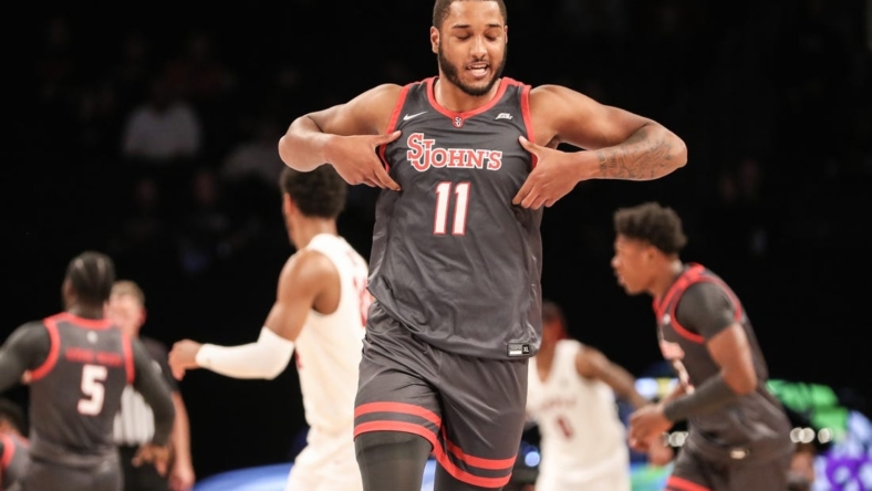 Nov 21, 2022; Brooklyn, New York, USA;  St. John's Red Storm center Joel Soriano (11) celebrates after scoring in the first half against the Temple Owls at Barclays Center. Mandatory Credit: Wendell Cruz-USA TODAY Sports