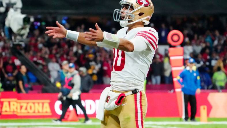 Nov 21, 2022; Mexico City, MEX; San Francisco 49ers quarterback Jimmy Garoppolo (10) celebrates after his touchdown pass against the Arizona Cardinals during the second half at Estadio Azteca. Mandatory Credit: Rob Schumacher-USA TODAY Sports