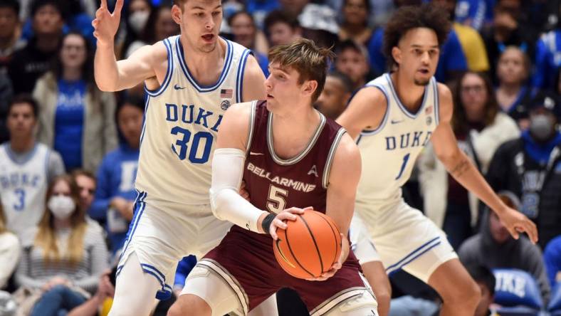 Nov 21, 2022; Durham, North Carolina, USA;  Bellarmine Knights guard Peter Suter (5) controls the ball against Duke Blue Devils center Kyle Filipowski (30) during the second half at Cameron Indoor Stadium. Mandatory Credit: Rob Kinnan-USA TODAY Sports