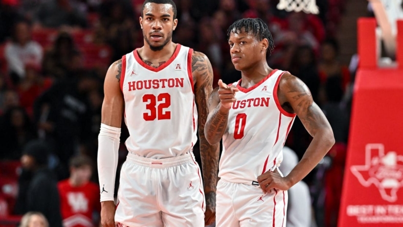 Nov 16, 2022; Houston, Texas, USA; Houston Cougars guard Marcus Sasser (0) and forward Reggie Chaney (32) stand on the court during the first half against the Texas Southern Tigers at Fertitta Center. Mandatory Credit: Maria Lysaker-USA TODAY Sports