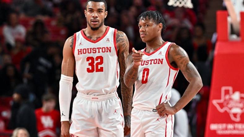 Nov 16, 2022; Houston, Texas, USA; Houston Cougars guard Marcus Sasser (0) and forward Reggie Chaney (32) stand on the court during the first half against the Texas Southern Tigers at Fertitta Center. Mandatory Credit: Maria Lysaker-USA TODAY Sports