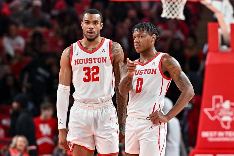 Nov 16, 2022; Houston, Texas, USA; Houston Cougars guard Marcus Sasser (0) and forward Reggie Chaney (32) stand on the court during the first half against the Texas Southern Tigers at Fertitta Center. Mandatory Credit: Maria Lysaker-USA TODAY Sports