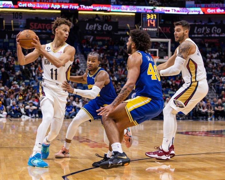 Nov 21, 2022; New Orleans, Louisiana, USA;  New Orleans Pelicans guard Dyson Daniels (11) looks to pass the ball against Golden State Warriors forward Anthony Lamb (40) during the second half at Smoothie King Center. Mandatory Credit: Stephen Lew-USA TODAY Sports