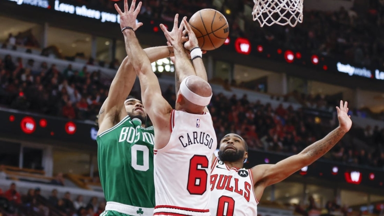 Nov 21, 2022; Chicago, Illinois, USA; Boston Celtics forward Jayson Tatum (0) is defended by Chicago Bulls guard Alex Caruso (6) and guard Coby White (0) during the second half at United Center. Mandatory Credit: Kamil Krzaczynski-USA TODAY Sports