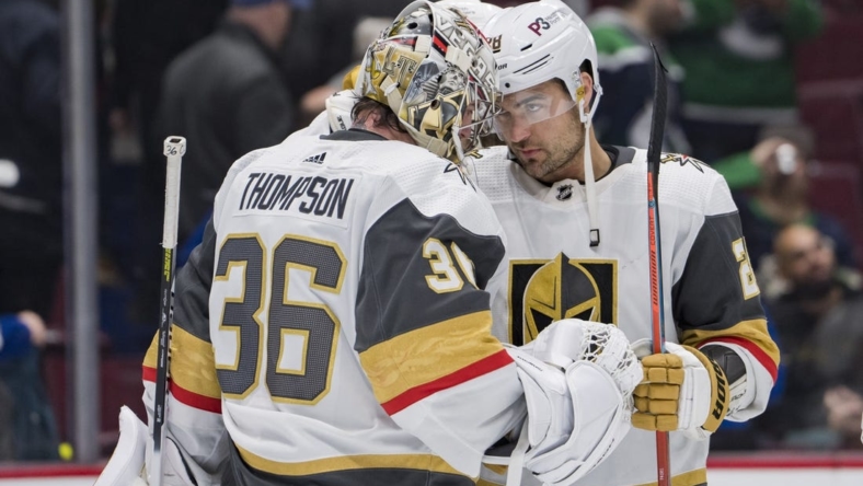 Nov 21, 2022; Vancouver, British Columbia, CAN; Vegas Golden Knights goalie Logan Thompson (36) and forward William Carrier (28) celebrate their victory against the Vancouver Canucks at Rogers Arena. Vegas won 5-4. Mandatory Credit: Bob Frid-USA TODAY Sports