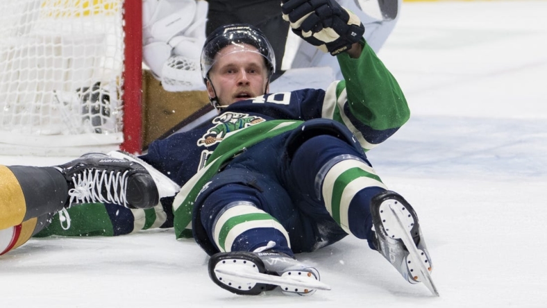 Nov 21, 2022; Vancouver, British Columbia, CAN; Vancouver Canucks forward Elias Pettersson (40) lays on the ice after a collision with Vegas Golden Knights defenseman Shea Theodore (27) in the third period at Rogers Arena. Vegas won 5-4. Mandatory Credit: Bob Frid-USA TODAY Sports