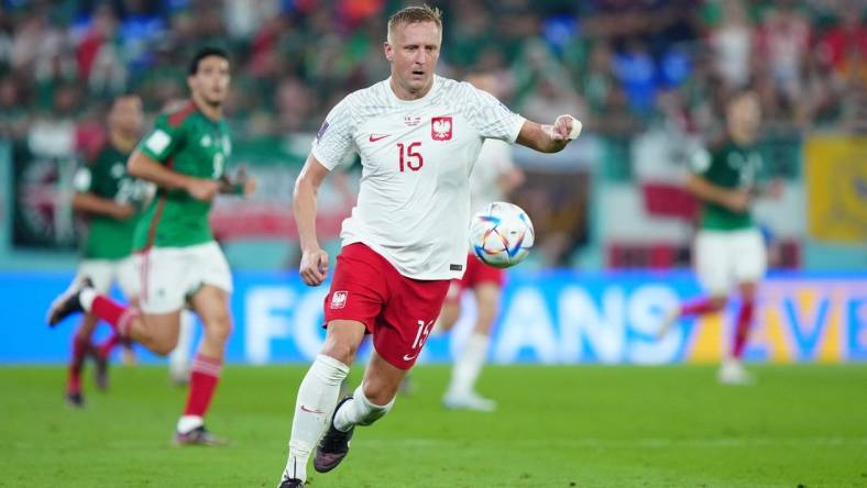 Nov 22, 2022; Doha, Qatar; Poland defender Kamil Glik (15) moves the ball during the second half against Mexico in a group stage match at the 2022 World Cup at Stadium 974. Mandatory Credit: Danielle Parhizkaran-USA TODAY Sports