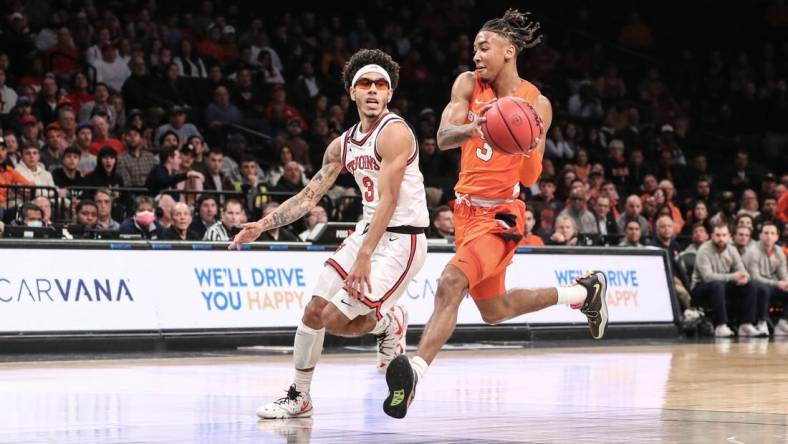 Nov 22, 2022; Brooklyn, New York, USA;  Syracuse Orange guard Judah Mintz (3) drives past St. John's Red Storm guard Andre Curbelo (3) in the first half at Barclays Center. Mandatory Credit: Wendell Cruz-USA TODAY Sports