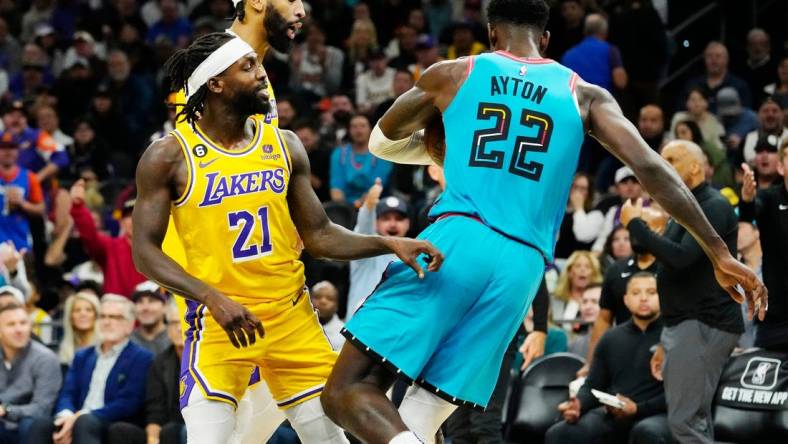 Nov 22, 2022; Phoenix, AZ, USA; Los Angeles Lakers guard Patrick Beverley (21) pushes Phoenix Suns center Deandre Ayton (22) to the court in the second half at Footprint Center. Beverley was ejected from the game. Mandatory Credit: Rob Schumacher-Arizona Republic