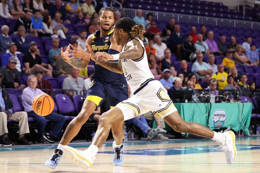 Nov 23, 2022; Fort Myers, Florida, USA;  Georgia Tech Yellow Jackets guard Deivon Smith (5) steals the ball from Marquette Golden Eagles forward David Joplin (23) in the first half during the Fort Myers Tip-Off Beach Division third place game at Suncoast Credit Union Arena. Mandatory Credit: Nathan Ray Seebeck-USA TODAY Sports