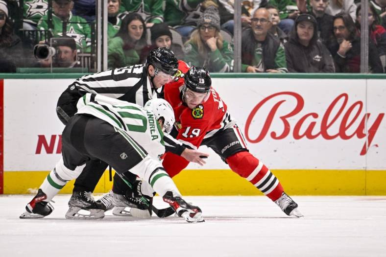 Nov 23, 2022; Dallas, Texas, USA; Dallas Stars center Ty Dellandrea (10) and Chicago Blackhawks center Jonathan Toews (19) battle for the puck during the face-off during the first period at the American Airlines Center. Mandatory Credit: Jerome Miron-USA TODAY Sports
