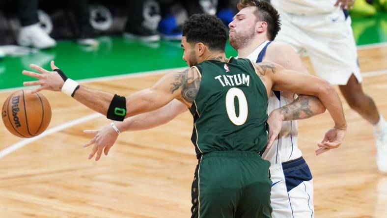 Nov 23, 2022; Boston, Massachusetts, USA; Dallas Mavericks guard Luka Doncic (77) works for the ball against Boston Celtics forward Jayson Tatum (0) in the fourth quarter at TD Garden. Mandatory Credit: David Butler II-USA TODAY Sports