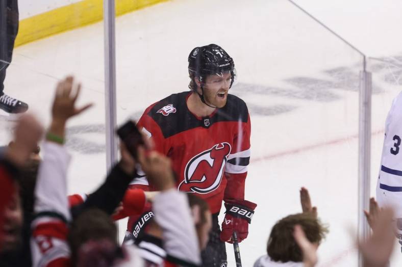 Nov 23, 2022; Newark, New Jersey, USA; New Jersey Devils defenseman Dougie Hamilton (7) celebrates his goal against the Toronto Maple Leafs during the third period at Prudential Center. Mandatory Credit: Ed Mulholland-USA TODAY Sports