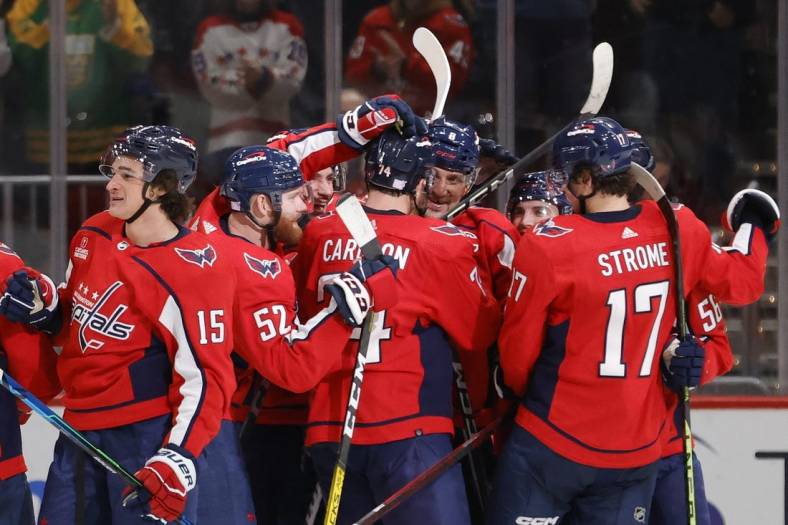 Nov 23, 2022; Washington, District of Columbia, USA; Washington Capitals left wing Alex Ovechkin (8) celebrates with teammates after scoring the game winning goal against the Philadelphia Flyers in overtime at Capital One Arena. Mandatory Credit: Geoff Burke-USA TODAY Sports