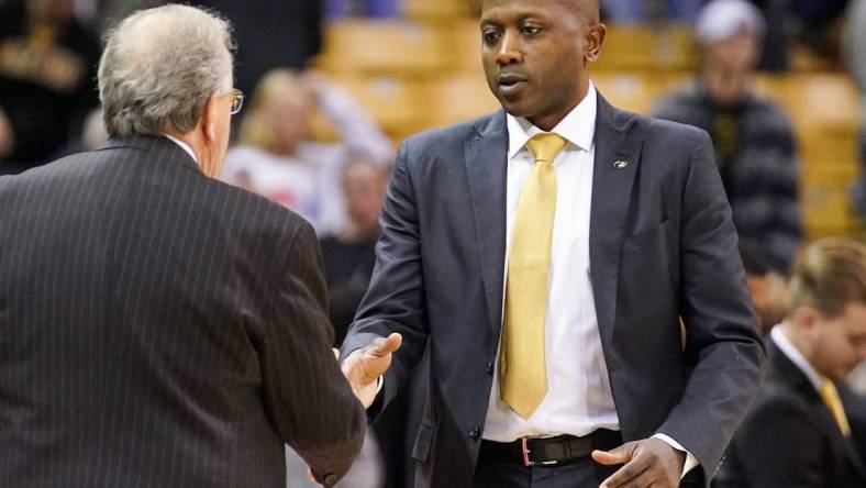 Nov 23, 2022; Columbia, Missouri, USA; Coastal Carolina Chanticleers head coach Cliff Ellis, left, shakes hands with Missouri Tigers head coach Dennis Gates after a game at Mizzou Arena. Mandatory Credit: Denny Medley-USA TODAY Sports