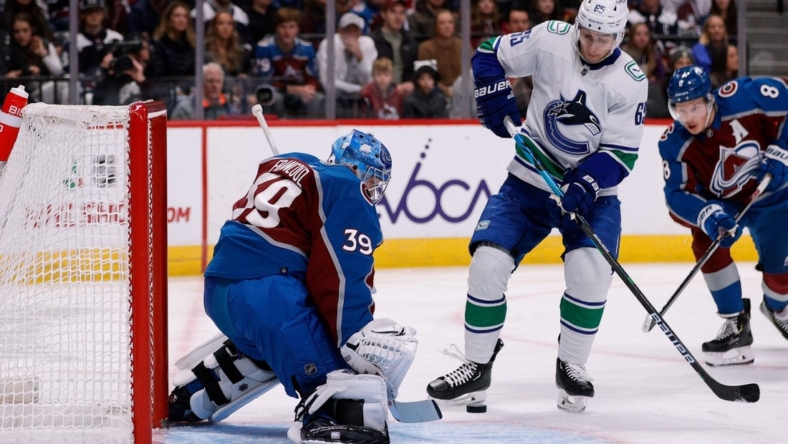 Nov 23, 2022; Denver, Colorado, USA; Colorado Avalanche goaltender Pavel Francouz (39) makes a save against Vancouver Canucks right wing Ilya Mikheyev (65) in the first period at Ball Arena. Mandatory Credit: Isaiah J. Downing-USA TODAY Sports