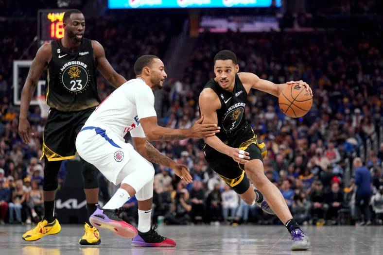 Nov 23, 2022; San Francisco, California, USA; Golden State Warriors guard Jordan Poole (3) dribbles past Los Angeles Clippers guard Norman Powell (24) in the first quarter at the Chase Center. Mandatory Credit: Cary Edmondson-USA TODAY Sports