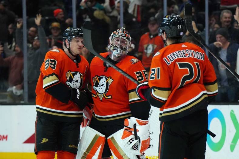 Nov 23, 2022; Anaheim, California, USA; Anaheim Ducks right wing Jakob Silfverberg (33), goaltender John Gibson (36) and center Isac Lundestrom (21) celebrate after the game against the New York Rangers at Honda Center. Mandatory Credit: Kirby Lee-USA TODAY Sports
