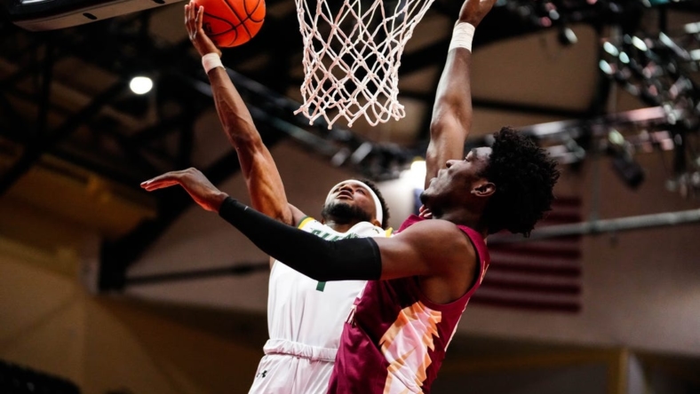 Nov 24, 2022; Orlando, FL, USA; Siena Saints guard Jared Billups (1) shoots as Florida State Seminoles center Naheem McLeod (24) attempts to block during the first half at ESPN Wide World of Sports. Mandatory Credit: Rich Storry-USA TODAY Sports