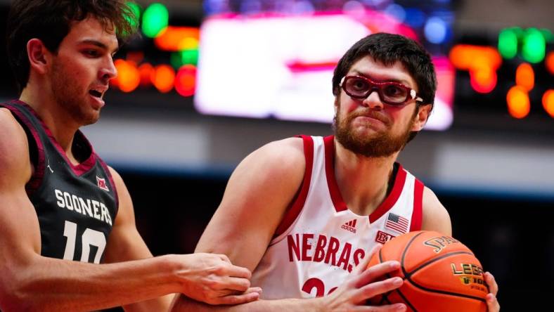 Nov 24, 2022; Orlando, Florida, USA; Nebraska Cornhuskers forward Oleg Kojenets (33) battles for possession with Oklahoma Sooners forward Yaya Keita (11) during the first half at State Farm Field House. Mandatory Credit: Rich Storry-USA TODAY Sports