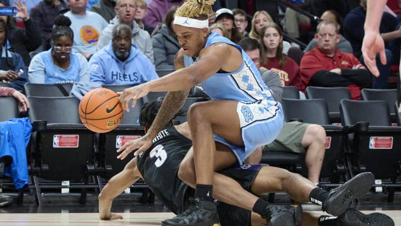 Nov 24, 2022; Portland, Oregon, USA; North Carolina Tar Heels forward Armando Bacot (5) and Portland Pilots forward Alden Applewhite (3) scramble for the ball during the second half at Moda Center. North Carolina won the game 89-81. Mandatory Credit: Troy Wayrynen-USA TODAY Sports