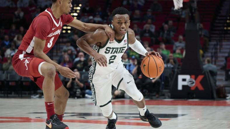 Nov 24, 2022; Portland, Oregon, USA;  Michigan State Spartans guard Tyson Walker (2) drives to the basket during the first half against Alabama Crimson Tide guard Rylan Griffen (3) at Moda Center. Mandatory Credit: Troy Wayrynen-USA TODAY Sports