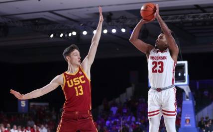 Nov 25, 2022; Paradise Island, BAHAMAS; Wisconsin Badgers guard Chucky Hepburn (23) shoots over USC Trojans guard Drew Peterson (13) during the first half at Imperial Arena. Mandatory Credit: Kevin Jairaj-USA TODAY Sports