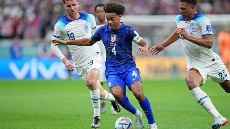 Nov 25, 2022; Al Khor, Qatar; United States of America midfielder Tyler Adams (4) dribbles the ball against England during the first half of a group stage match during the 2022 World Cup at Al Bayt Stadium. Mandatory Credit: Danielle Parhizkaran-USA TODAY Sports