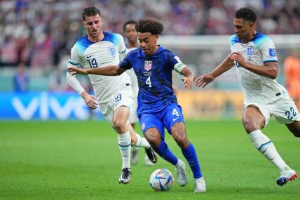 Nov 25, 2022; Al Khor, Qatar; United States of America midfielder Tyler Adams (4) dribbles the ball against England during the first half of a group stage match during the 2022 World Cup at Al Bayt Stadium. Mandatory Credit: Danielle Parhizkaran-USA TODAY Sports