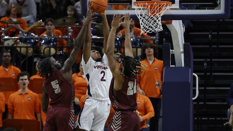 Nov 25, 2022; Charlottesville, Virginia, USA; Virginia Cavaliers guard Reece Beekman (2) attempts to dunk the bal as Maryland-Eastern Shore Hawks guard Da'Shawn Phillip (5) and Hawks forward Troy Hupstead (24) defend in the first half at John Paul Jones Arena. Mandatory Credit: Geoff Burke-USA TODAY Sports