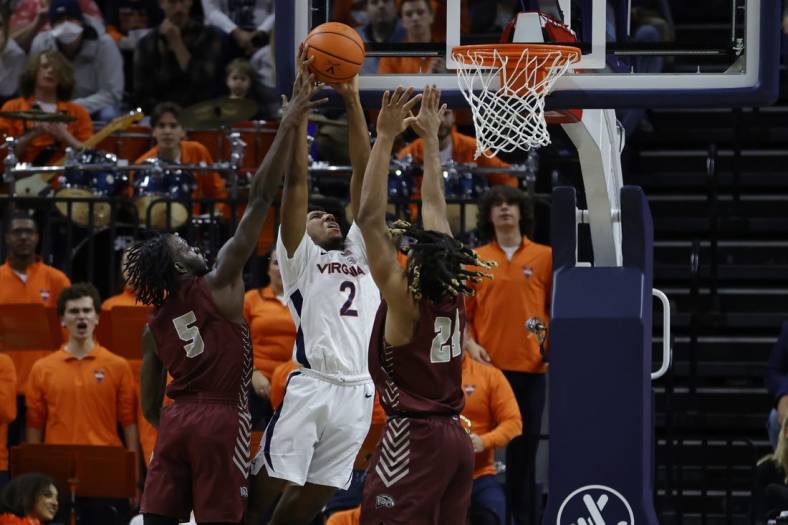 Nov 25, 2022; Charlottesville, Virginia, USA; Virginia Cavaliers guard Reece Beekman (2) attempts to dunk the bal as Maryland-Eastern Shore Hawks guard Da'Shawn Phillip (5) and Hawks forward Troy Hupstead (24) defend in the first half at John Paul Jones Arena. Mandatory Credit: Geoff Burke-USA TODAY Sports