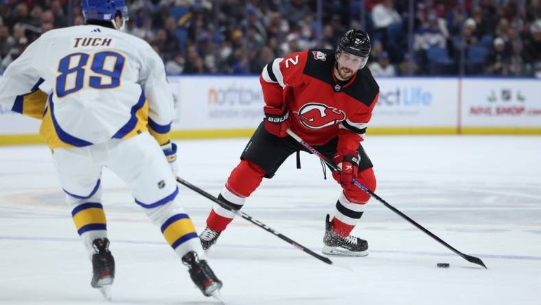 Nov 25, 2022; Buffalo, New York, USA;  Buffalo Sabres right wing Alex Tuch (89) looks to block a pass by New Jersey Devils defenseman Brendan Smith (2) during the first period at KeyBank Center. Mandatory Credit: Timothy T. Ludwig-USA TODAY Sports