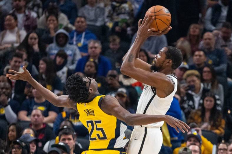 Nov 25, 2022; Indianapolis, Indiana, USA; Brooklyn Nets forward Kevin Durant (7) shoots the ball while Indiana Pacers forward Jalen Smith (25) defends in the second quarter at Gainbridge Fieldhouse. Mandatory Credit: Trevor Ruszkowski-USA TODAY Sports