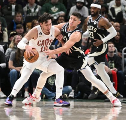 Nov 25, 2022; Milwaukee, Wisconsin, USA; Milwaukee Bucks guard Grayson Allen (12) reaches for the ball against Cleveland Cavaliers forward Cedi Osman (16) in the second quarter at Fiserv Forum. Mandatory Credit: Michael McLoone-USA TODAY Sports