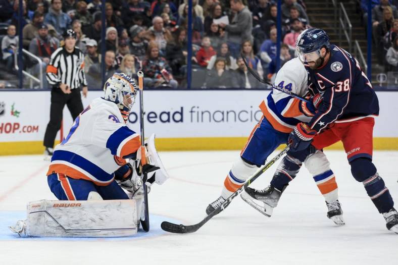Nov 25, 2022; Columbus, Ohio, USA;  New York Islanders goaltender Ilya Sorokin (30) defends the net as Columbus Blue Jackets center Boone Jenner (38) controls the puck against New York Islanders center Jean-Gabriel Pageau (44) in the second period at Nationwide Arena. Mandatory Credit: Aaron Doster-USA TODAY Sports