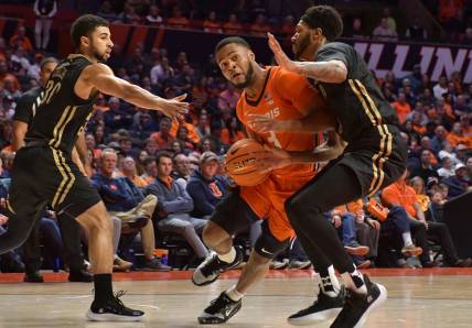Nov 25, 2022; Champaign, Illinois, USA; Illinois Fighting Illini guard Jayden Epps (3) drives the ball between Lindenwood Lions guard Chris Childs (30) and Lindenwood Lions forward Cam Burell (5) during the first half at State Farm Center. Mandatory Credit: Ron Johnson-USA TODAY Sports